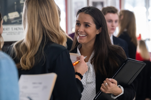 A student talks to a recruiter at a Miami University career fair.